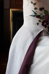 Tara Lynn lined the skirt with a contrast color to pop match the poppies on this hemp silk wedding gown.